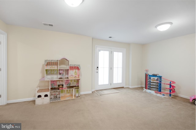 recreation room with carpet floors and baseboards