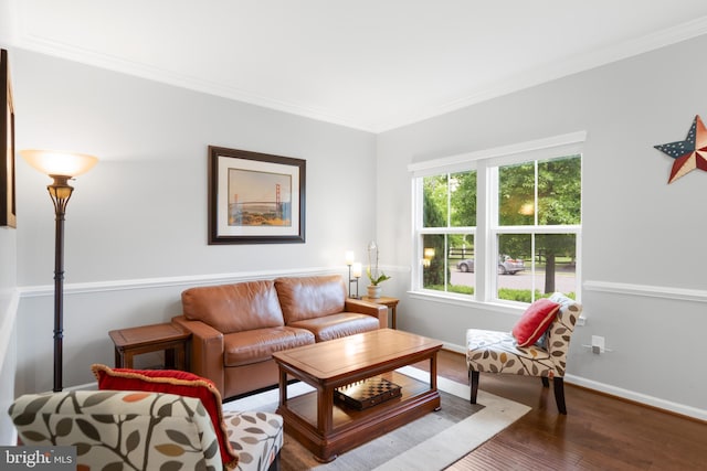 living area featuring ornamental molding, wood finished floors, and baseboards
