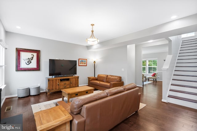 living room with stairs, dark wood-type flooring, recessed lighting, and baseboards