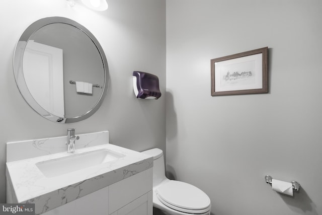 bathroom featuring toilet and vanity