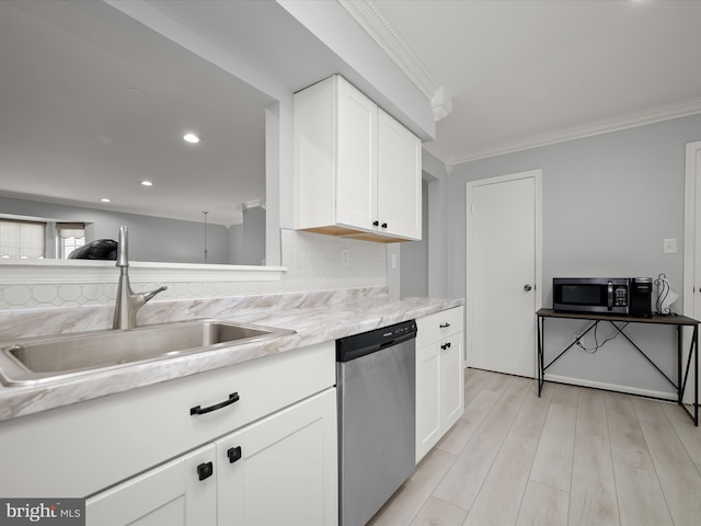 kitchen with stainless steel appliances, crown molding, a sink, white cabinetry, and light countertops