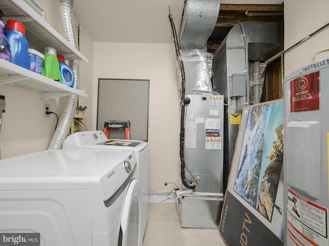 laundry room with washer and dryer and light tile patterned floors