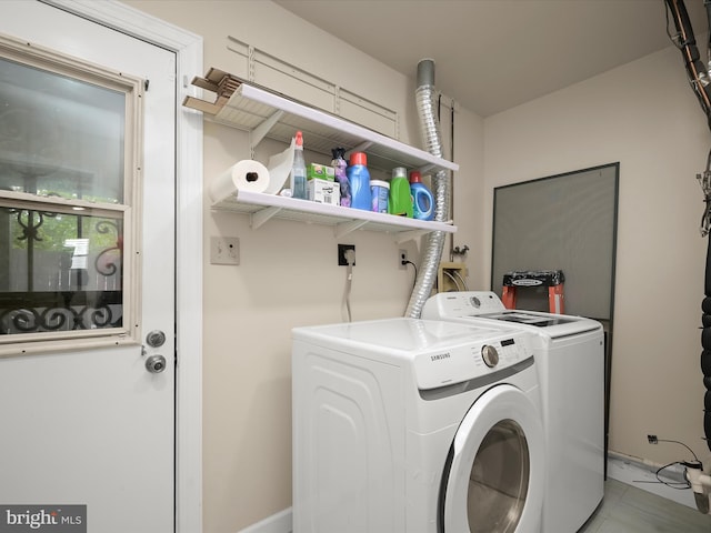 laundry area featuring separate washer and dryer and baseboards
