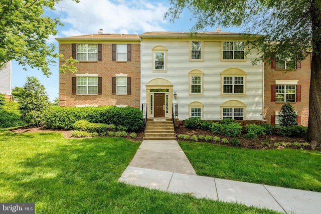 12106 Green Leaf Ct Unit 102, Fairfax, VA 22033 - view of front of home featuring a front yard, a chimney, and brick siding