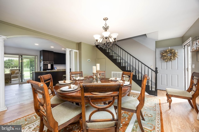 26882 Pratt Rd, Salisbury, MD 21801 - dining area with ornate columns, stairway, a chandelier, light wood-style flooring, and recessed lighting