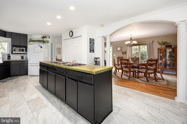 26882 Pratt Rd, Salisbury, MD 21801 - kitchen with ornate columns, stainless steel appliances, dark cabinetry, recessed lighting, and a center island