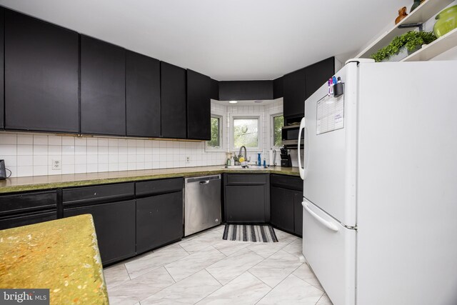 26882 Pratt Rd, Salisbury, MD 21801 - kitchen featuring appliances with stainless steel finishes, a sink, dark cabinetry, backsplash, and light countertops