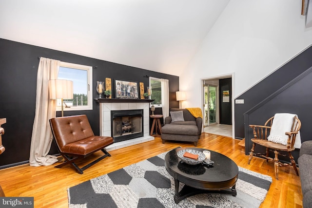 26882 Pratt Rd, Salisbury, MD 21801 - living area featuring healthy amount of natural light, a fireplace, wood finished floors, and high vaulted ceiling
