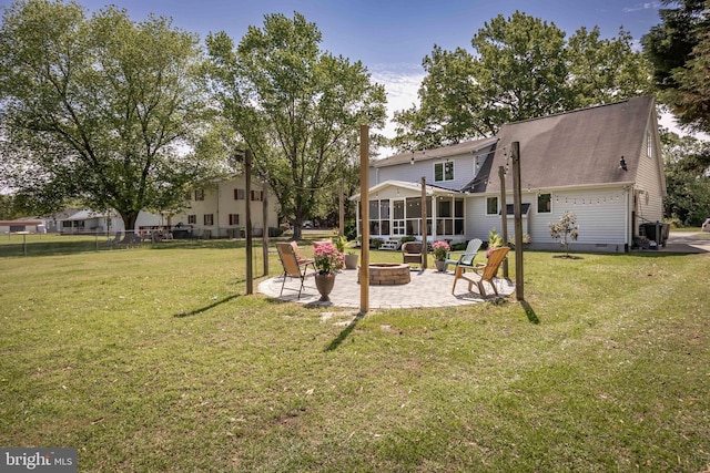 26882 Pratt Rd, Salisbury, MD 21801 - back of house with an outdoor fire pit, a sunroom, a patio area, and a yard