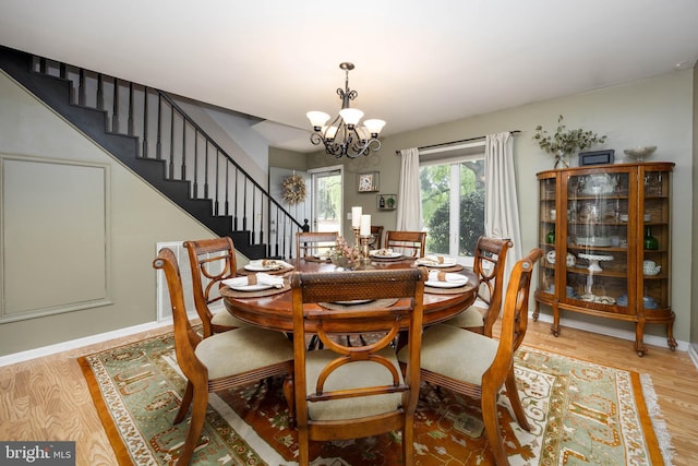 26882 Pratt Rd, Salisbury, MD 21801 - dining space featuring a chandelier, light wood finished floors, stairway, and baseboards