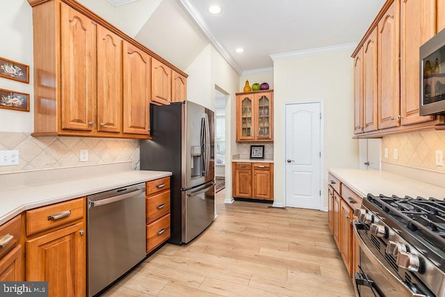 111 Central Parke E, Ocean Pines, MD 21811 - kitchen with appliances with stainless steel finishes, crown molding, decorative backsplash, recessed lighting, and light wood-type flooring