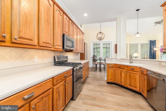 111 Central Parke E, Ocean Pines, MD 21811 - kitchen featuring appliances with stainless steel finishes, brown cabinets, light wood-type flooring, light countertops, and recessed lighting