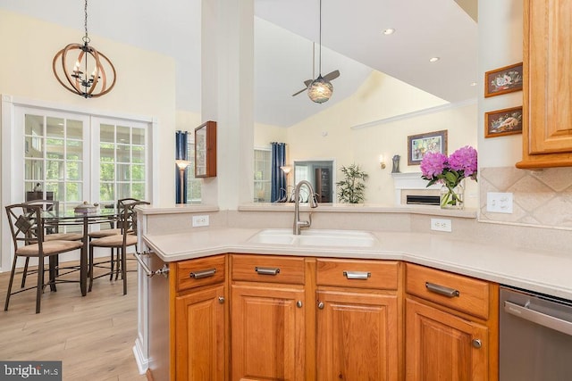111 Central Parke E, Ocean Pines, MD 21811 - kitchen featuring stainless steel dishwasher, a sink, light countertops, high vaulted ceiling, and a chandelier