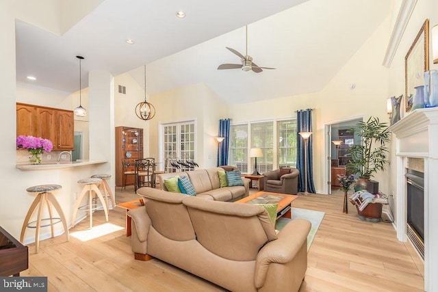 111 Central Parke E, Ocean Pines, MD 21811 - living room featuring high vaulted ceiling, light wood finished floors, ceiling fan, a glass covered fireplace, and recessed lighting