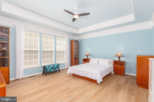111 Central Parke E, Ocean Pines, MD 21811 - bedroom featuring a raised ceiling, crown molding, light wood-style flooring, baseboards, and a ceiling fan