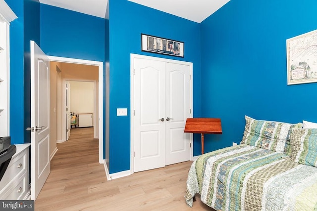 111 Central Parke E, Ocean Pines, MD 21811 - bedroom featuring light wood-style flooring, a closet, a towering ceiling, and baseboards