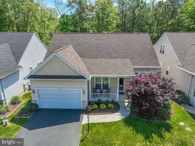 111 Central Parke E, Ocean Pines, MD 21811 - view of front of home with a porch, an attached garage, a shingled roof, driveway, and a front yard