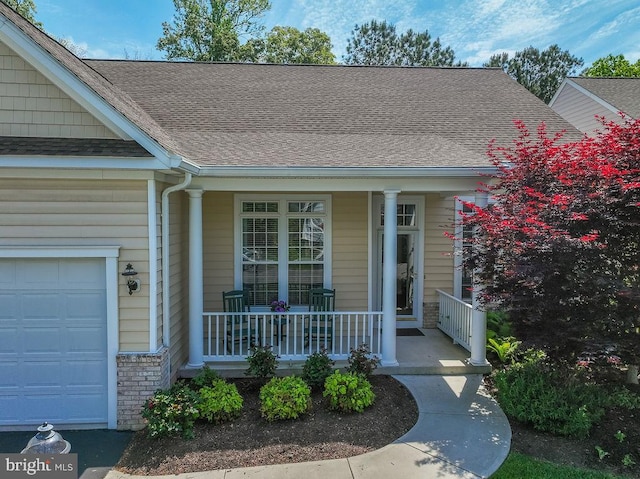 111 Central Parke E, Ocean Pines, MD 21811 - view of exterior entry with a porch, a garage, and roof with shingles
