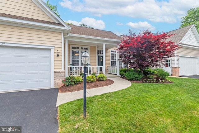 111 Central Parke E, Ocean Pines, MD 21811 - view of front facade featuring a porch, a front lawn, driveway, an attached garage, and brick siding