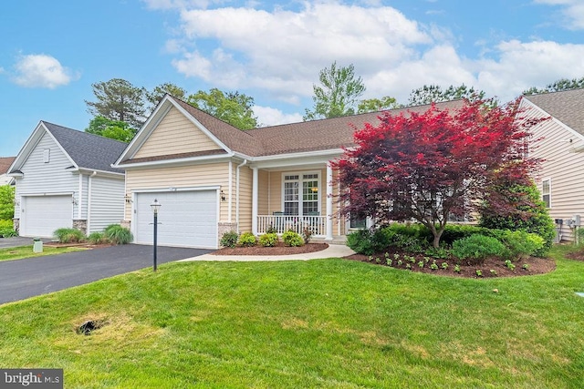 111 Central Parke E, Ocean Pines, MD 21811 - view of front facade with covered porch, driveway, a front lawn, and a garage