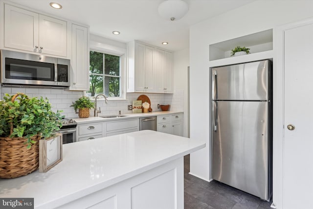 129 Kreutz Ave, Doylestown, PA 18901 - kitchen with stainless steel appliances, a sink, decorative backsplash, light countertops, and recessed lighting