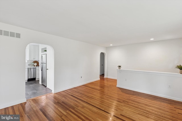 129 Kreutz Ave, Doylestown, PA 18901 - spare room with arched walkways, wood finished floors, recessed lighting, and baseboards