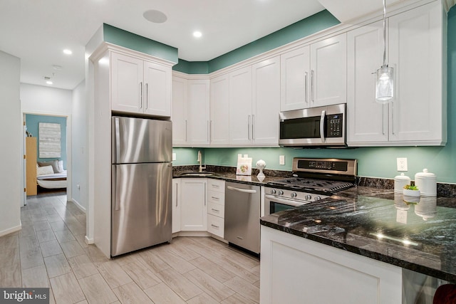 756 Park Rd NW Unit 2, Washington, DC 20010 - kitchen with stainless steel appliances, a sink, dark stone countertops, recessed lighting, and baseboards