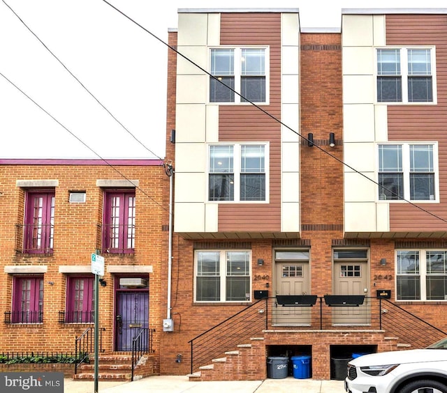 view of property featuring brick siding
