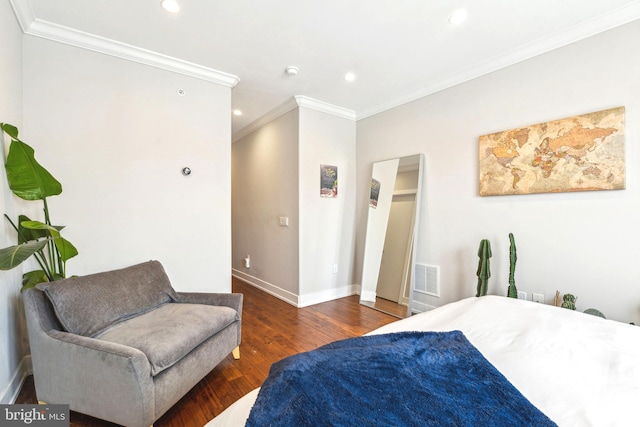 bedroom with ornamental molding, wood finished floors, baseboards, and recessed lighting