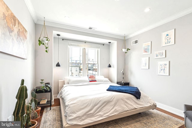 bedroom with wood finished floors, baseboards, crown molding, and recessed lighting