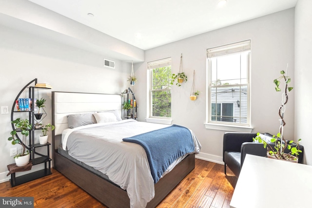 bedroom with wood-type flooring, baseboards, and recessed lighting