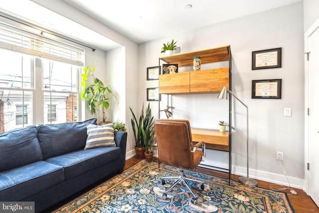 office area with baseboards and wood finished floors