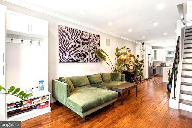 living room featuring stairs, ornamental molding, dark wood-style floors, and recessed lighting