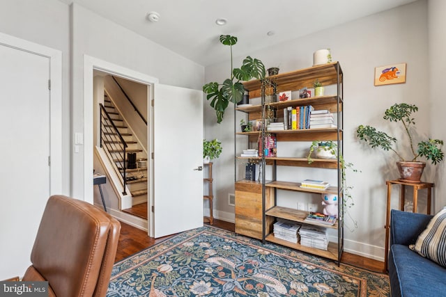 sitting room with stairway, wood finished floors, and baseboards