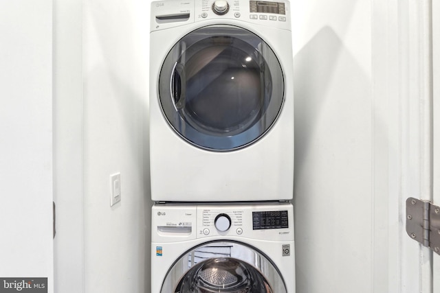 laundry area with stacked washer / dryer
