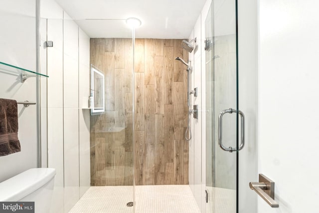 full bath with toilet and a shower stall