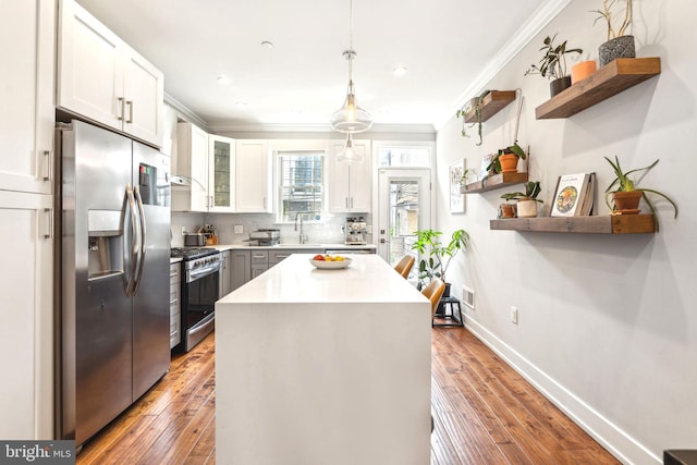 kitchen featuring stainless steel appliances, open shelves, crown molding, wall chimney exhaust hood, and white cabinetry