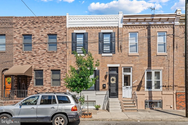 view of property featuring brick siding and entry steps