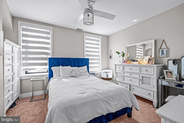 bedroom with carpet floors, multiple windows, and ceiling fan