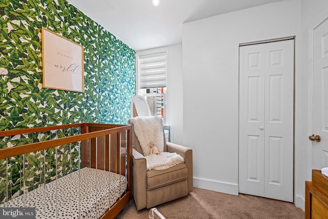 carpeted bedroom featuring wallpapered walls and baseboards