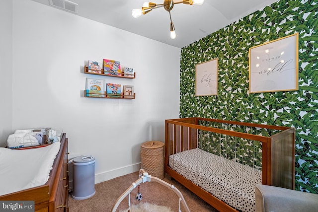 carpeted bedroom with wallpapered walls and baseboards