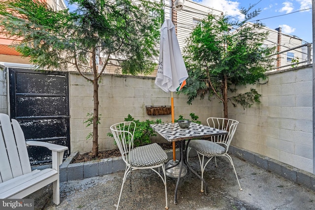 view of patio featuring outdoor dining space and fence