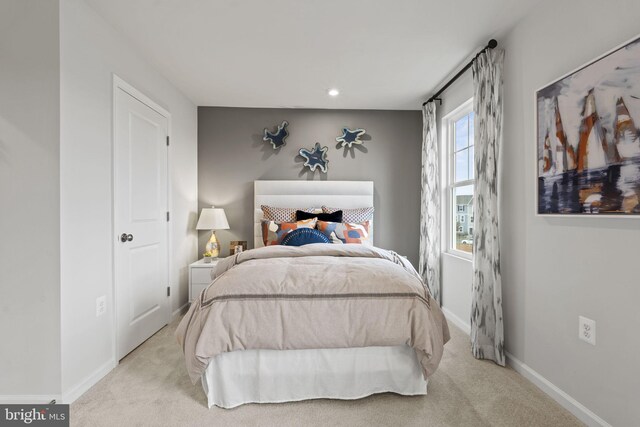 carpeted bedroom featuring baseboards and recessed lighting