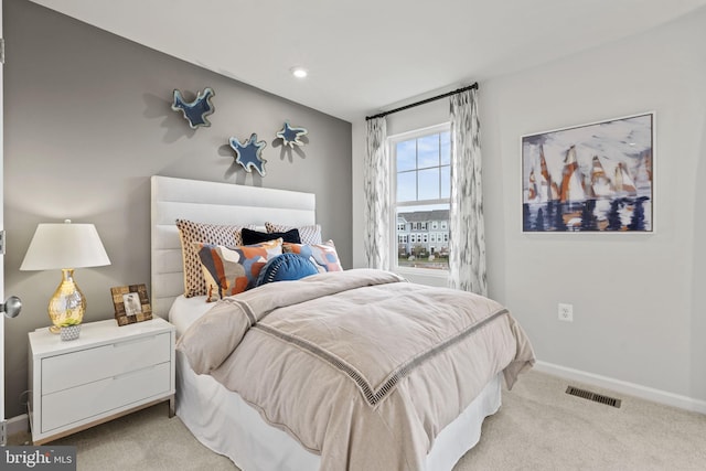 bedroom with light colored carpet, baseboards, and recessed lighting