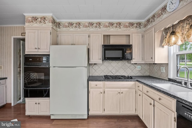 kitchen with black appliances, a warming drawer, a sink, ornamental molding, and tasteful backsplash