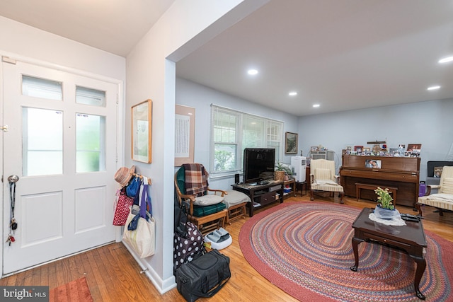living area with wood finished floors and recessed lighting
