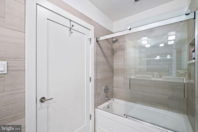 bathroom featuring combined bath / shower with glass door