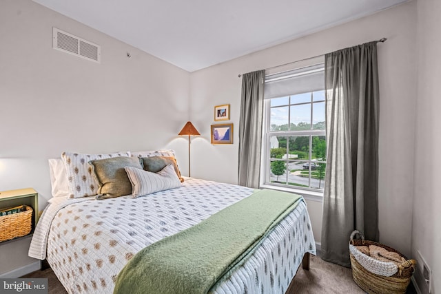 bedroom featuring baseboards and dark colored carpet