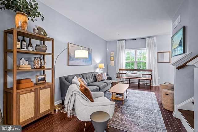 living room featuring dark wood-style flooring and baseboards