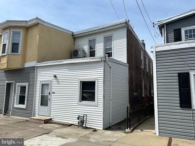 402 Market St, Marcus Hook, PA 19061 - rear view of property featuring ac unit, fence, and stucco siding